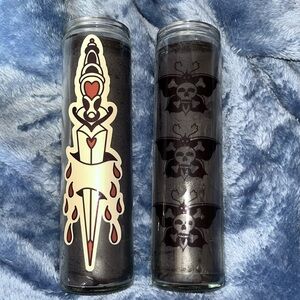 Two black candles with traditional tattoo accents and style